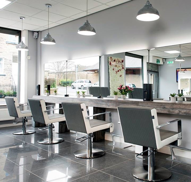 grey and white salon chairs in a hairdressers room