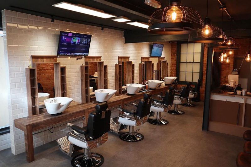 industrial barber shop with tv and white bricks london style