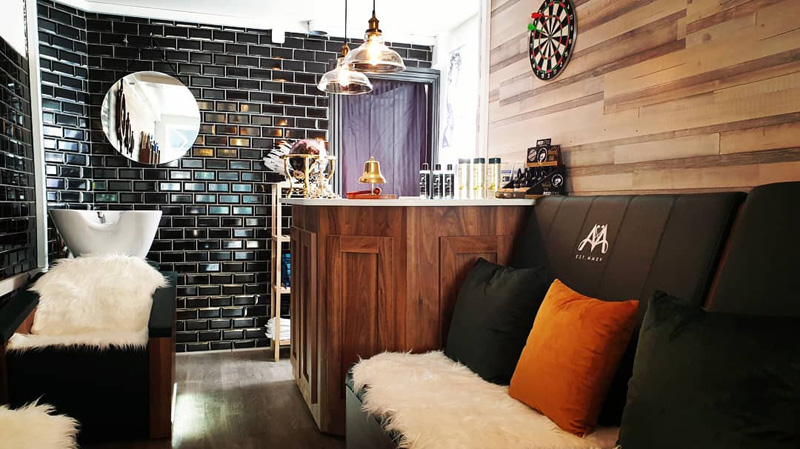 cozy rustic barbers shop with black tiles and faux fur covers