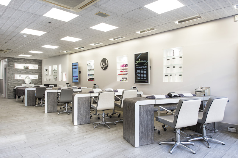 bright light nail salon with chairs and desks