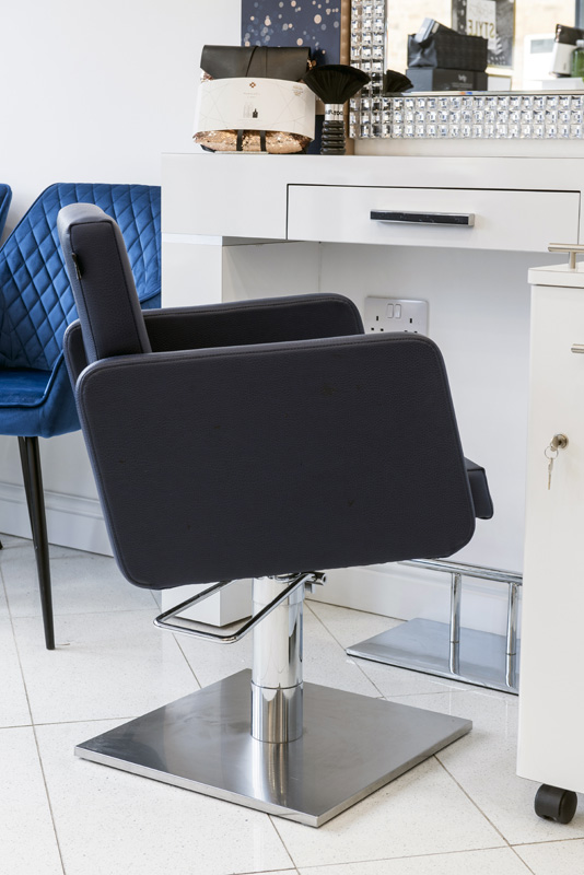 black salon chair with white desk