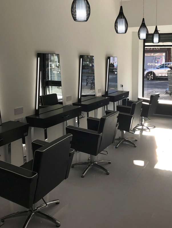 hair salon with styling mirror and chairs