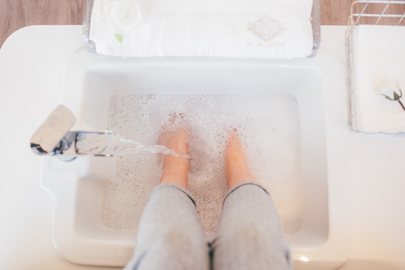 foot spa basin with bubbles and tap